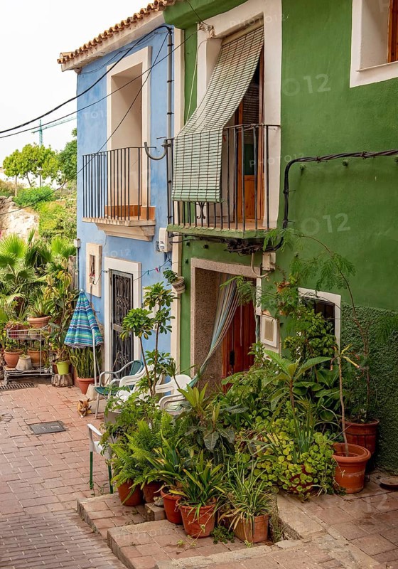 Close-up of colorful houses with flowerpots in Villajoyosa