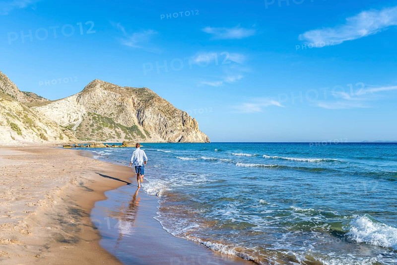 Young man walking on a beach