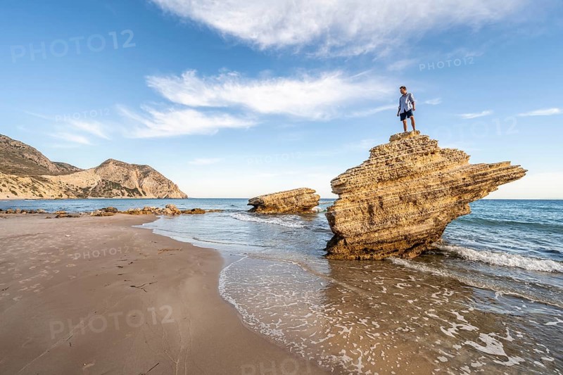 Young man standing on a rock