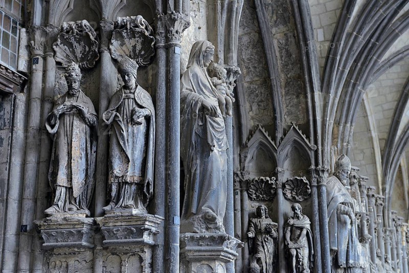 Old sculptures in need of renovation at the entrance gate to Notre-Dame Cathedral in Tournai