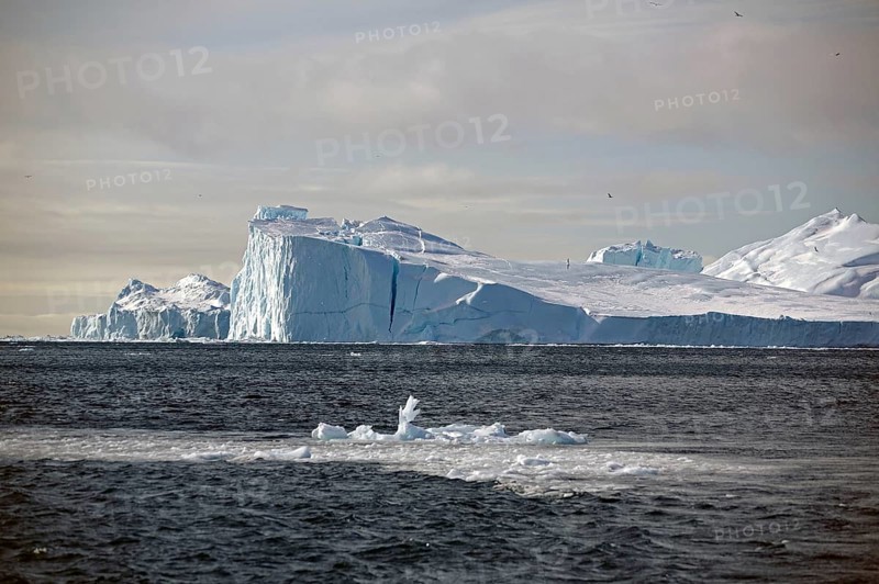 Individual pieces of ice in front of icebergs in the sea