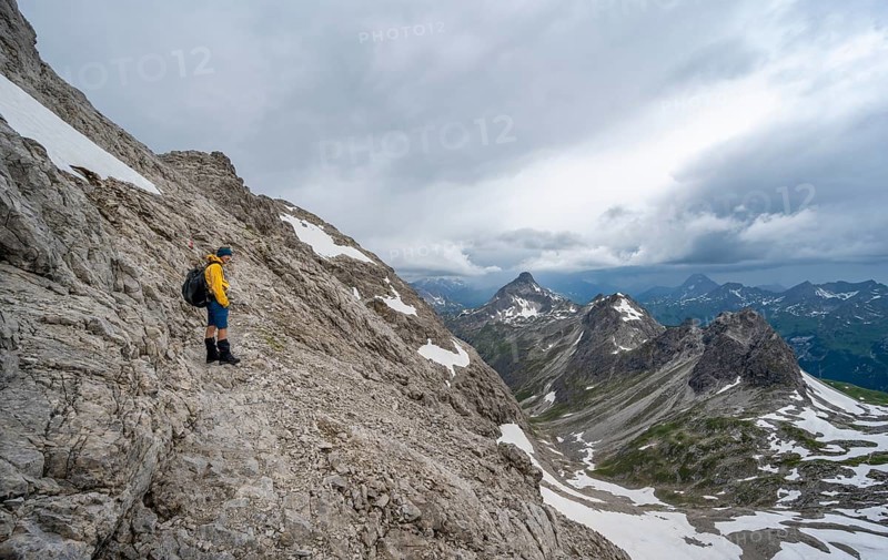 Hiker on hiking trail in rocky terrain
