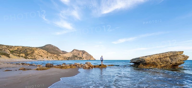 Young man standing on a rock