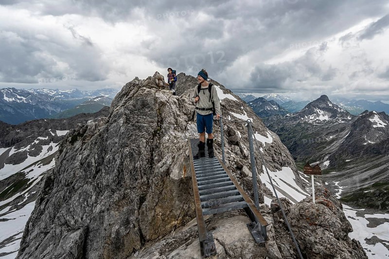 Hiker on a metal bridge on a rock