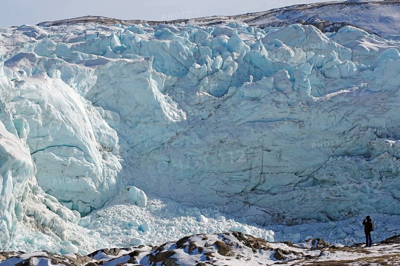 Man in front of the break-off edge of the Russell Glacier