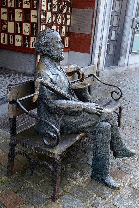 Sculpture of Adolphe Sax with saxophone in front of his birthplace