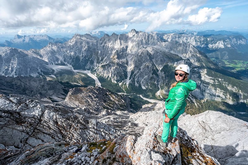 Hiker with helmet at the summit of the Watzmann