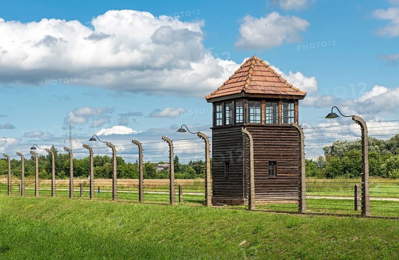 Barbed-wire fence and watch-tower at Auschwitz II-Birkenau concentration camp