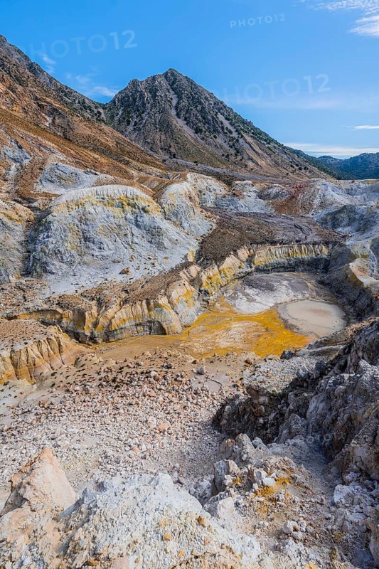 Crater with yellow discoloured sulphur stones and colourful mineral deposits