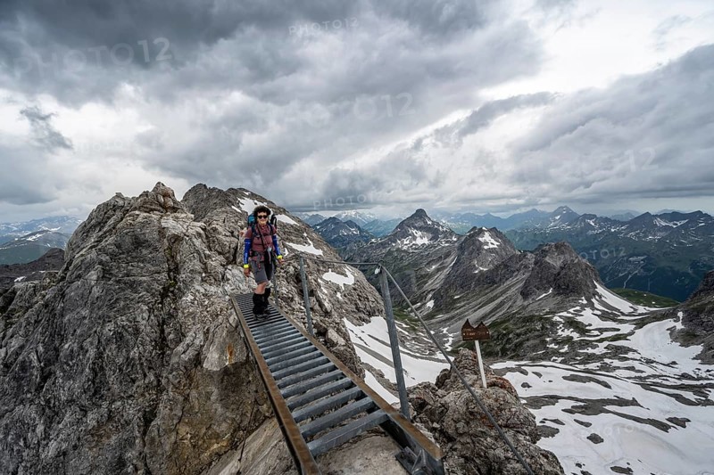 Hiker on a metal bridge on a rock