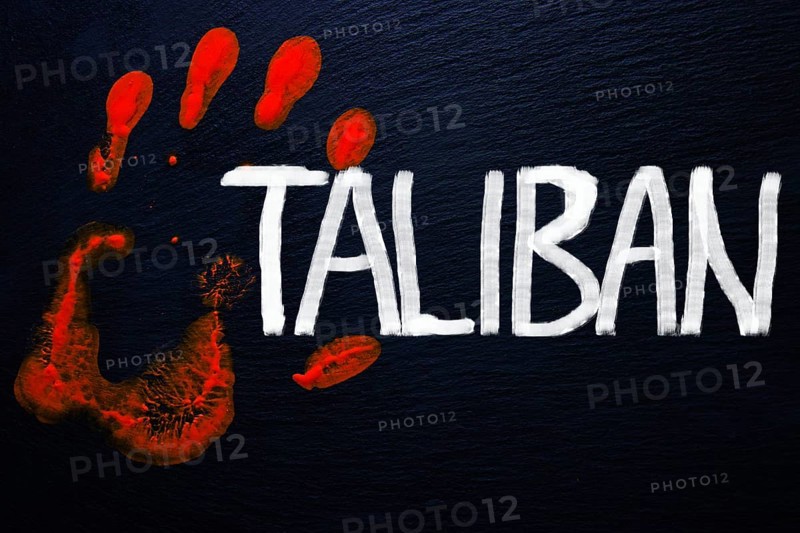Slate with a bloody handprint and the inscription Taliban