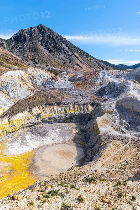 Crater with yellow discoloured sulphur stones and colourful mineral deposits