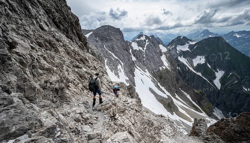 Hiker and woman descending rocky terrain