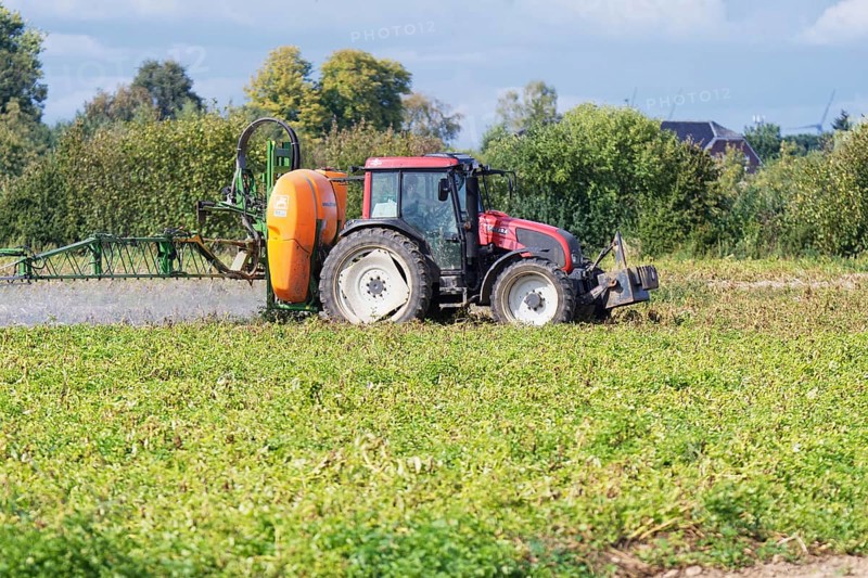 Farmer spraying pesticides