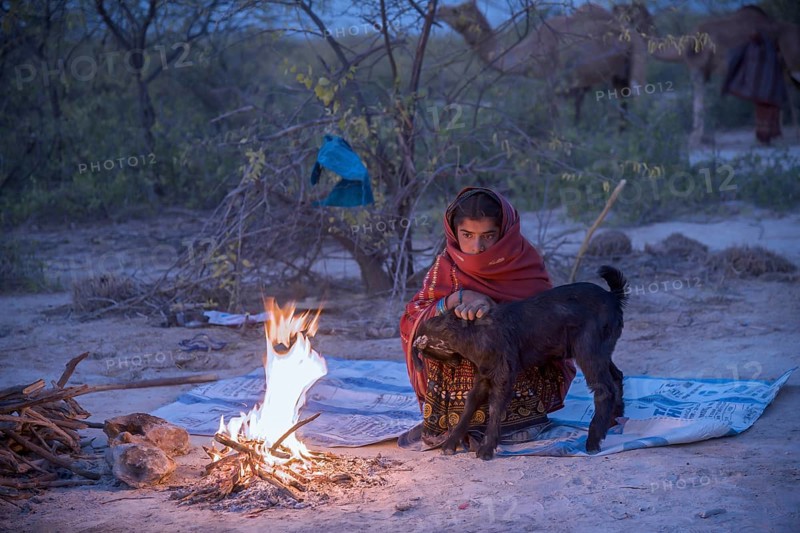 Fakirani next to a wood fire camp in the early morning