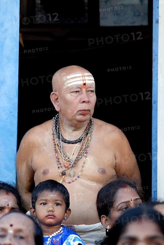 An old brahmin man watching the Arupathumoovar festival