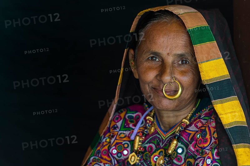 Elderly Ahir woman in traditional colorful cloth with a nose ring