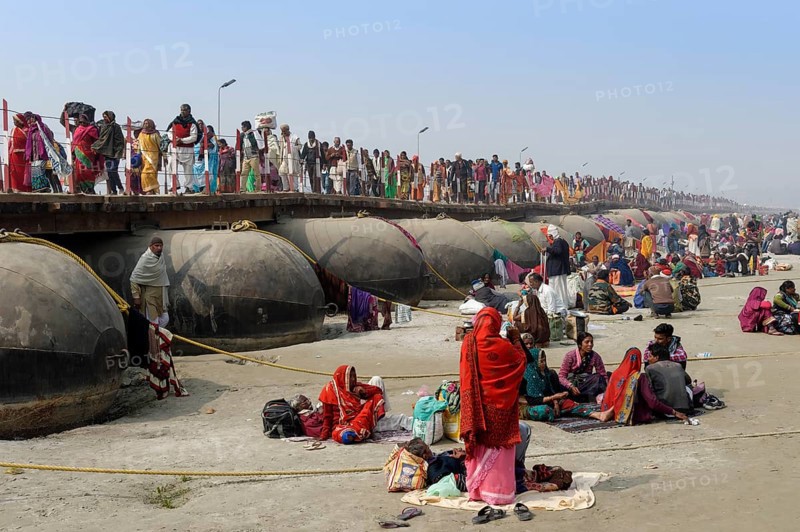Pilgrims cross the Ganges on a makeshift pontoon bridge