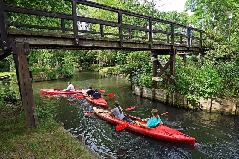 Tourists paddle through the village of Lehde