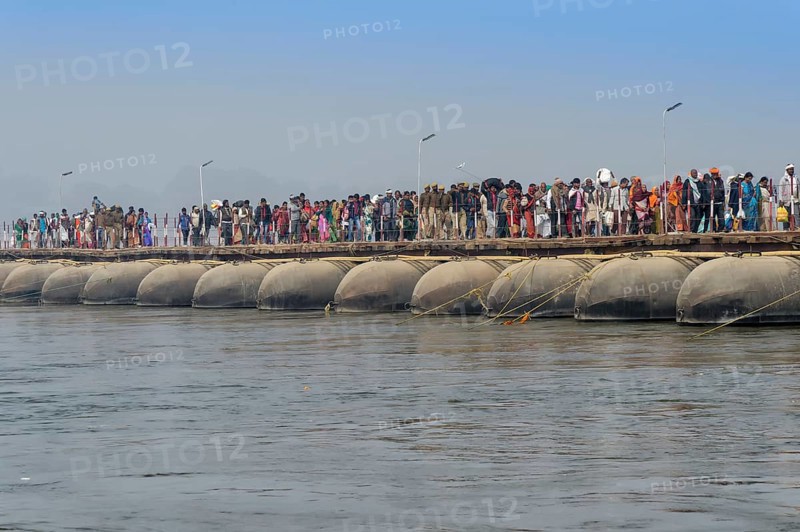 Pilgrims cross the Ganges on a makeshift pontoon bridge