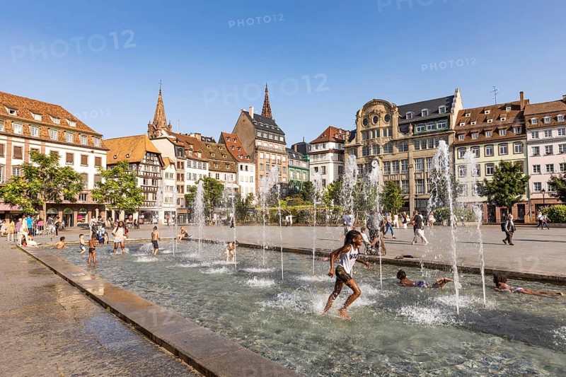 Children playing in a fountain at Place Kleber