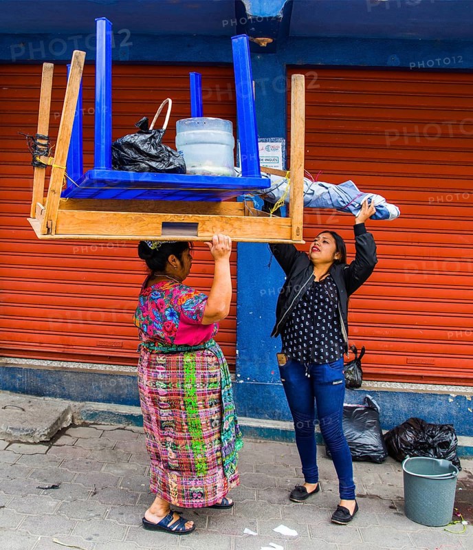Market woman carrying the entire market stall on her head