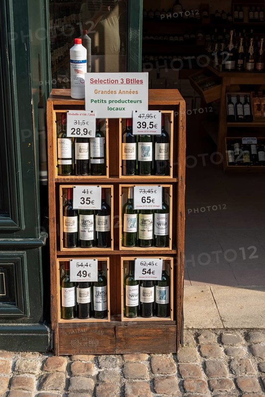 Wine bottles in front of a shop
