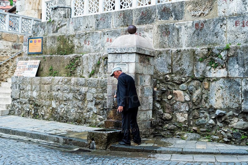 Man washing his hands at the well