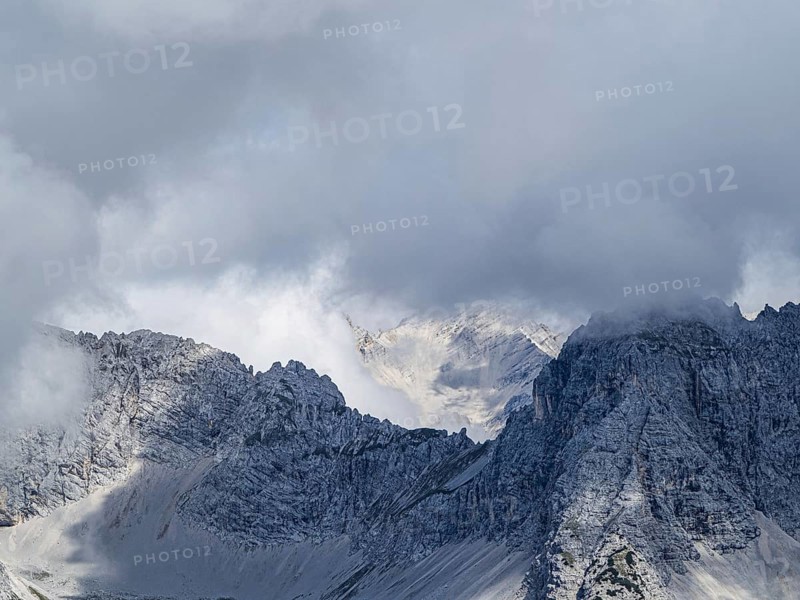 View from the Hafelekarspitze on misty mountain peaks in the Karwendel mountains