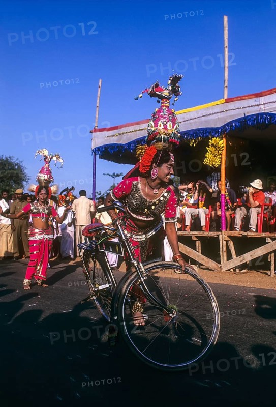 Folk dancer of Karakattam balancing on bicycle