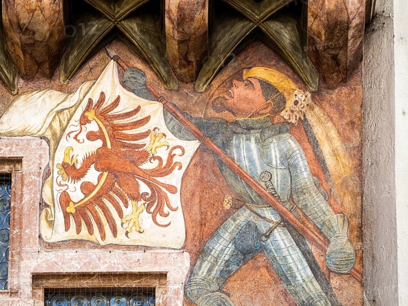 Banner bearer with armour carries white flag with red eagle