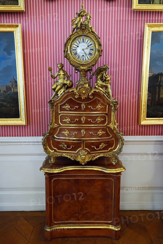 Historical clock on baroque furniture