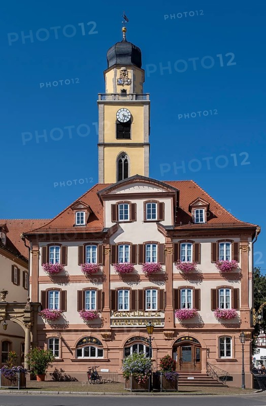 Twin house and church tower of St. John's Minster on the market square in Bad Mergentheim