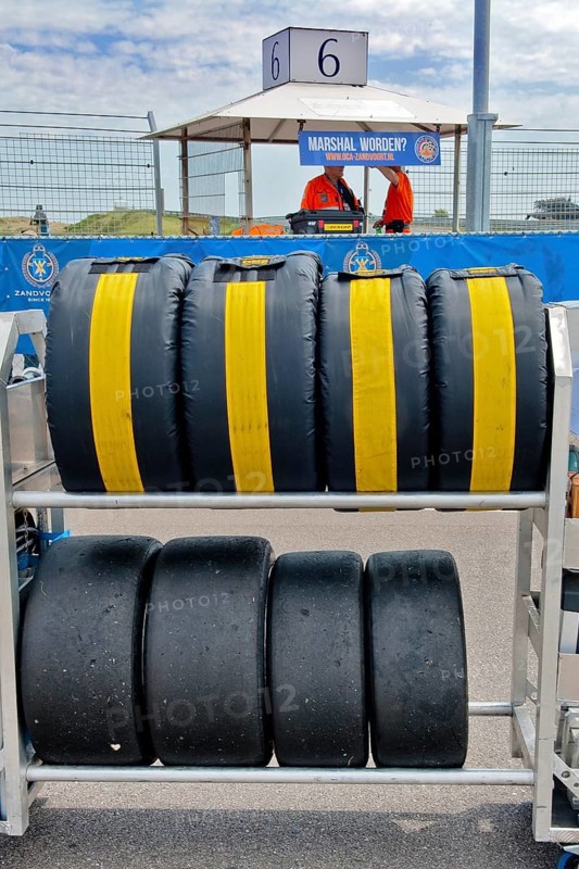 Mobile rack with racing tyres in protective cover for car racing