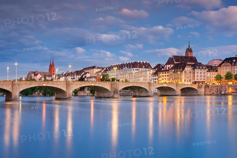 View of the old town of Basel illuminated at night with the Basel Cathedral