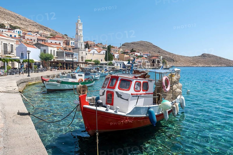 Fishing boats in the harbour of Halki with turquoise water