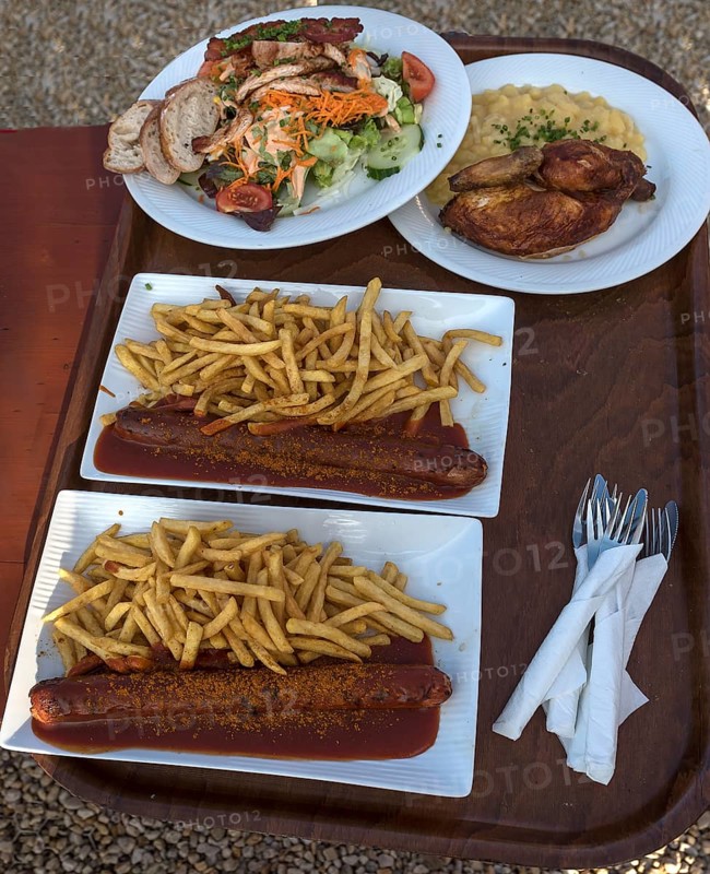 Currywurst with fries on a tray
