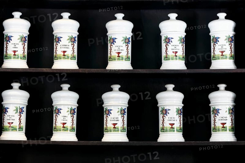 White ceramics with essences and ingedences on the shelf of old pharmacy