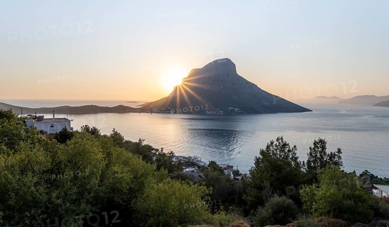 Sunshine over sea and hills in evening mood