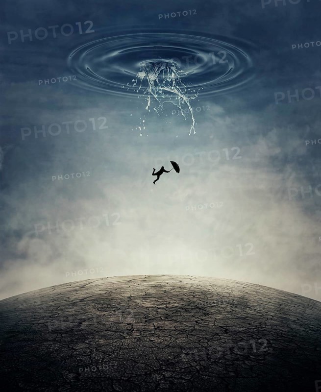 A silhouette of an young man with an umbrella falling from the sky as a splash of water crashing down to the cracked desert ground. Business risk