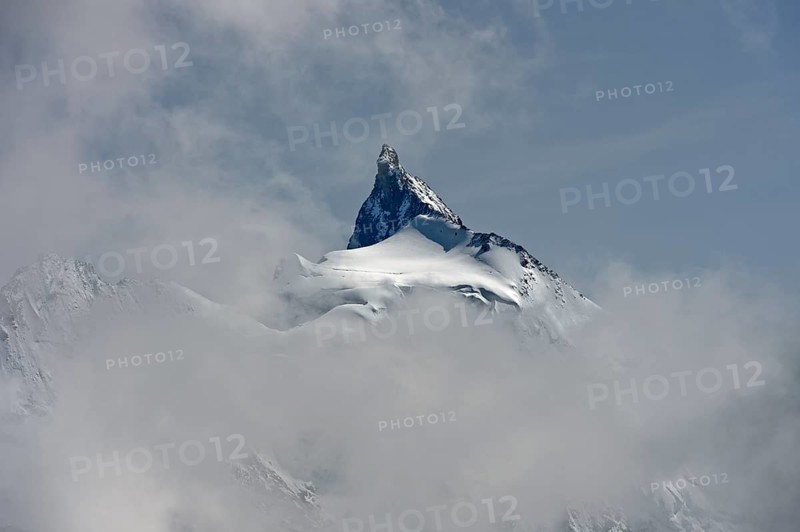 The Zinalrothorn peak rises out of the sea of clouds