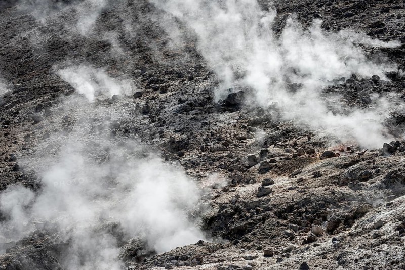 Steaming black volcanic soil
