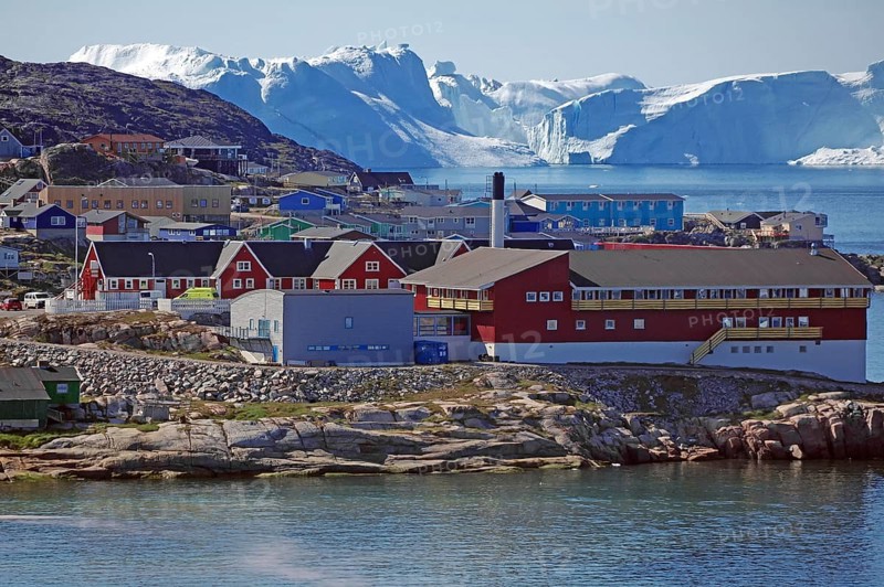 Buildings in front of icebergs