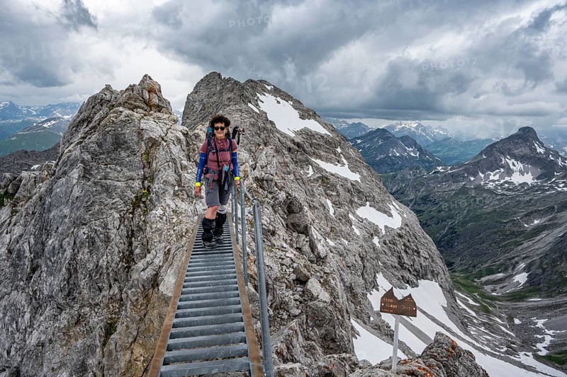 Hiker on a metal bridge on a rock