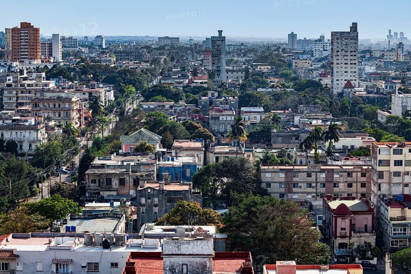 View over sea of houses with lots of greenery of the capital Havana