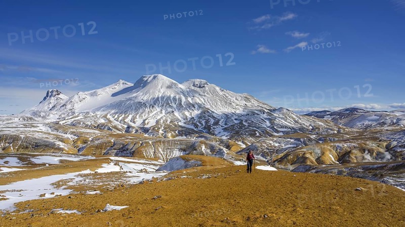 Woman in front of snowy mountains Loomundur Fannborg and Snaekollur in the hot spring area Hveradalir