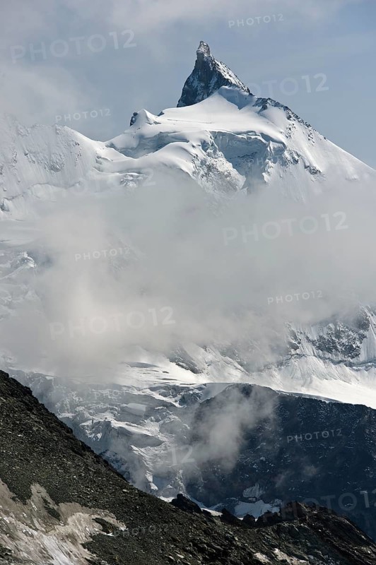 Peak Zinalrothorn rising from the sea of clouds