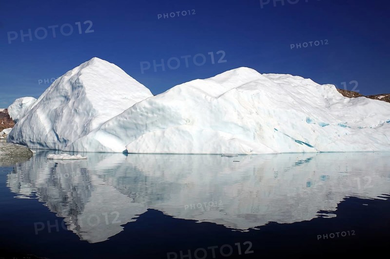 Iceberg reflected in a fjord