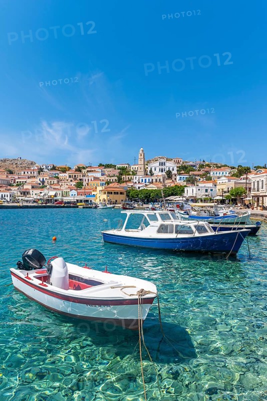 Fishing boats in the harbour of Halki with turquoise water