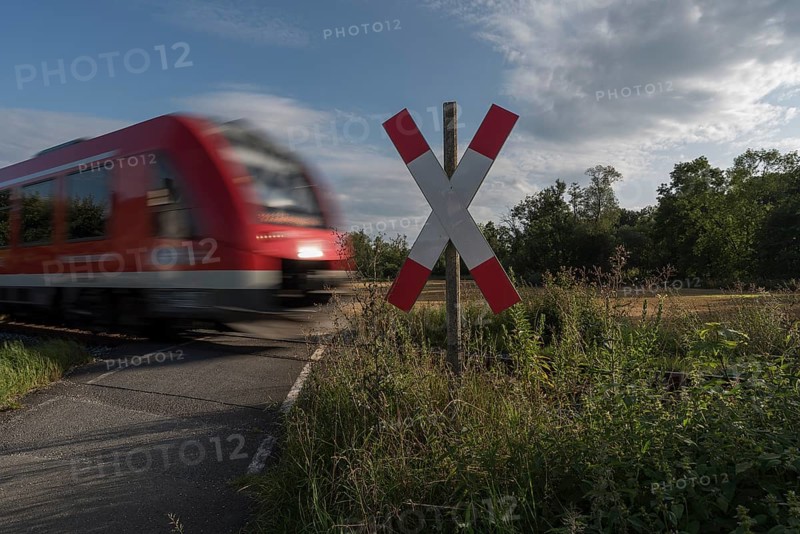 Unguarded level crossing with approaching train